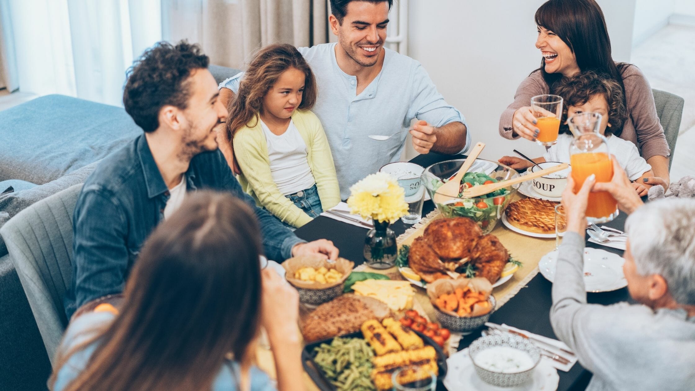 family enjoying a holiday meal | tips to stop overeating