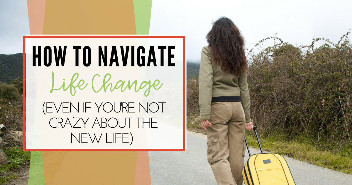 woman walking on an open road pulling a suitcase | life change